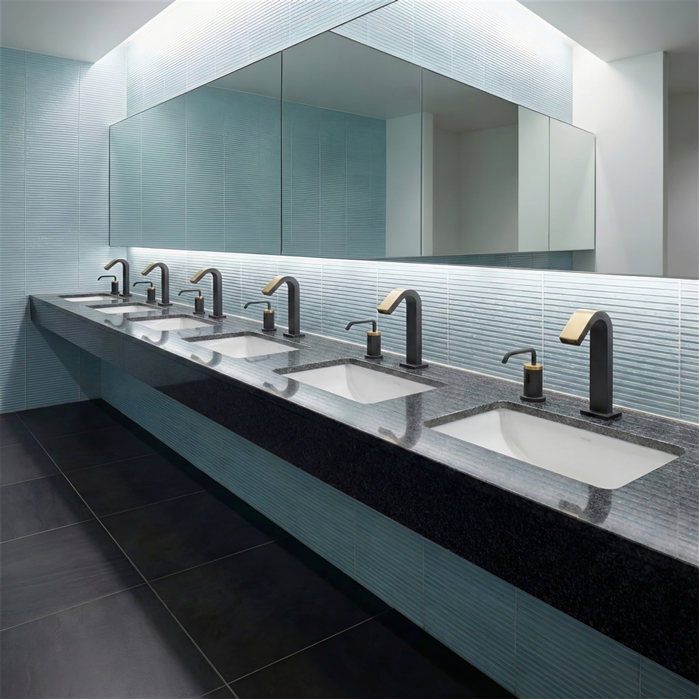 Close-up of a vandal-resistant commercial touchless faucet spout and sensor window